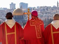 Latin Patriarch of Jerusalem Pierbattista Pizzaballa (C) holds a prayer during a Palm Sunday 