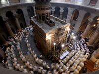 Christian worshippers, monks, and friars walk in procession around the Edicule, traditionally believed to be the burial site of Jesus Christ