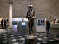 People visit an archaeological exhibit at Egypt's new National Museum of Egyptian Civilisation (NMEC)