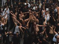 Shiite Muslim devotees take part in a procession to commemorate the death anniversary of Prophet Mohammad's companion and son-in-law Imam Ali in Lahore 