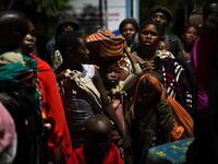 Congolese people carry their belongings as they flee from Goma, Democratic Republic of Congo (DRC), after the Nyiragongo volcano erupted, at the border point known as "Petite Barriere" in Gisenyi, Rwanda, on May 23, 2021. The government of the Democratic Republic of Congo has ordered the evacuation of the eastern city of Goma after the eruption of Mount Nyiragongo overlooking the border city. The lava reached the city's airport early Sunday, with an official from Virunga National Park 