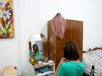 Albanian transgender Luana, puts her makeup on, in her house in Tirana 