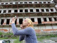 Albanian transgender Lola, puts her makeup on, in the former Communist-era maximum security prison for political prisoners in Spac