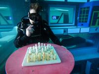 A diver plays mock chess as he experiences Deep Dive Dubai, the deepest swimming pool in the world reaching 60m, in the United Arab Emirates, on July 10, 2021. The city of superlatives, with the world's tallest tower among its many records, Dubai now has the deepest swimming pool on the planet complete with a "sunken city" for divers to explore. GIUSEPPE CACACE / AFP