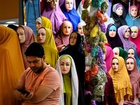 A vendor waits for customers at a shopping centre ahead of Eid al-Adha celebrations in Banda Aceh on July 17, 2021. CHAIDEER MAHYUDDIN / AFP