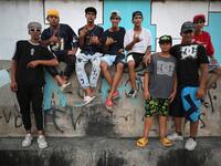 Iraqi youths pose for a picture as they gather to practice stunts on motorbikes and scooters in the Jadriya district of Baghdad on August 6, 2021. All dressed up and nowhere to go: many young Iraqis in Baghdad make an effort to be hip, even as they admit their country may have no future. 