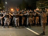 Demonstrators confront anti-riot policemen as they protest against against a proposed income tax draft law in front of the Prime Minister's office in Amman, late on June 1, 2018. 
STRINGER / AFP