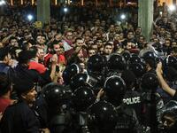 Jordanian protesters shout slogans before members of the gendarmerie and security forces during a demonstration outside the Prime Minister's office in the capital Amman late on June 2, 2018/AFP