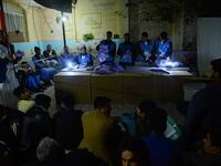 In this photo taken on October 20, 2018, Afghan Independent Election Commission (IEC) officials count ballot papers at a polling centre for the country's legislative election in Herat province. 
HOSHANG HASHIMI / AFP