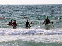 On one of the world's most polluted beaches, 30 young Palestinians dive head first into the sea off the coast of Gaza, their minds filled with dreams of Olympic glory. (SAID KHATIB / AFP)