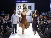 A model displays a chocolate dress created by founder of fashion brand Karoline Lang (R) at the 2018 chocolate fair fashion show in Beirut on November 8, 2018. 
JOSEPH EID / AFP