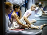 Girls attend a class at a ballet studio in Moscow on November 22, 2018. In a small studio in northern Moscow, parents and grandparents sit in a corridor waiting for children as young as three to finish their ballet class. 
Mladen ANTONOV / AFP