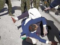 A Palestinian woman shields her injured husband as Palestinian security forces try to disperse a rally of Hamas supporters, marking the 31st anniversary of the founding of the Islamist movement.
HAZEM BADER / AFP