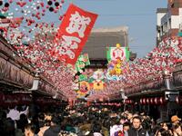 Visitors walk underneath New Year's Day decorations along the Nakamise shopping alley, the front approach to Sensoji Temple, in Tokyo on December 27, 2018. 
Kazuhiro NOGI / AFP