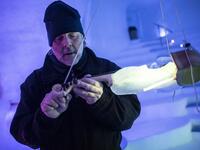 US artist Tim Linhart works on an ice violin in the "Ice Dome" on Presena Galcier, Tonale Pass, near Trento in northern Italy on January 18, 2018. 
Marco BERTORELLO / AFP