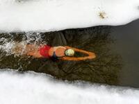 Natalya Seraya, the founder and chief of Moscow's ice swimming club "Walruses of the Capital", swims in a strip of water cut in the ice by the bank of the Moscow River on February 3, 2019. 
Kirill KUDRYAVTSEV / AFP