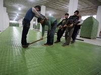 Syrian workers cut olive soap bars in a factory on the outskirts of Aleppo 
LOUAI BESHARA / AFP