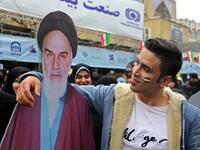 An Iranian man poses with a life-size cutout portrait of Islamic Revolution founder Ayatollah Ruhollah Khomeini during a ceremony celebrating the 40th anniversary of Islamic Revolution in the capital Tehran on February 11, 2019. 
ATTA KENARE / AFP