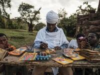 An Ethiopian Orthodox artist paints postcards in Lalibela, Ethiopia
EDUARDO SOTERAS / AFP