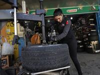 Amina repairs a flat tyre at a car tyre's repair shop in Beirut on March 8, 2019. Amina has been working for 10 years in mechanics, specially in the tyres repair business. She considers it fulfilling as she always dreamt of doing that job.
JOSEPH EID / AFP