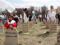 Iraqi-Kurds visit a grave site in Halabja near the monument for victims of the Halabja gas massacre 
Shwan MOHAMMED / AFP