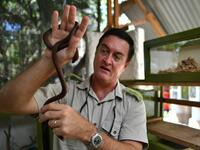The herpetologist and director of the Bio-Ken Snake Farm, Royjan Taylor, holds a small snake on February 13, 2019, in the Kenya's coastal town of Watamu, in Kilifi county. 
TONY KARUMBA / AFP
