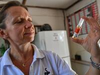 Clare, a nurse and wife of the Bio-Ken Snake Farm Director holds a vile of an anti-venom at the farm where snakes' venom is extracted for research and manufacture, on February 14, 2019, in Kenya's coastal town of Watamu, Kilifi county. 
TONY KARUMBA / AFP