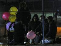 Palestinian protesters hold incendiary ballons that will be released over Israel, during a night demonstration near the fence along the border with Israel, in Rafah 
SAID KHATIB / AFP