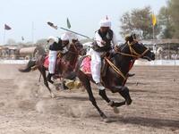 This photograph taken on March 27, 2019, shows Pakistani horse riders with lances used to pick up pegs during an attempt for a Guinness World Record for tent pegging in Khanewal district in Punjab province. 
SS MIRZA / AFP