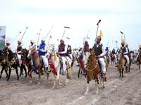 This photograph taken on March 27, 2019, shows Pakistani horse riders with lances used to pick up pegs during an attempt for a Guinness World Record for tent pegging in Khanewal district in Punjab province. 
SS MIRZA / AFP