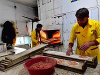 Bakers prepare local meat pies in the souk or market of Al-Hol camp for displaced people in northeastern Syria
GIUSEPPE CACACE / AFP