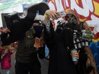 A Saudi woman uses her cell phone to take a "selfie" photograph with cosplayers while attending the first ever Comic-Con Arabia event held in the capital Riyadh on November 25, 2017. 

(FAYEZ NURELDINE / AFP)