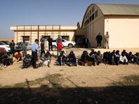 Sub-Saharan migrants sit at the Qanfouda detention center, in the southern outskirts of Benghazi, before being repatriated, on Dec. 2, 2017. 
(Abdullah DOMA / AFP)