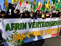 Protesters hold a giant banner reading "To defend Afrin means to defend life" during a demonstration of Kurdish groups to protest against Turkey's offensive against Kurds in Syria's Afrin region, on Mar. 3, 2018 in Berlin. 
(John MACDOUGALL / AFP)