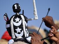 A 'jockey robot' on top of a camel ahead of a race (Twitter) 