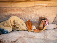 Bedouin sleeps near the rock in the desert of Wadi Rum. Bedouins are a part of a desert-dwelling Arabian ethnic group (Shutterstock/File Photo) 