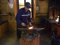 Algerian farrier Meddah Larbi hammers a horseshoe at a horse breeding farm, one of the oldest and largest farm in Algeria, perched on the high plateaux in the country's Tiaret region, 300 Kilometres west of Algiers, on April 24, 2018. 
RYAD KRAMDI / AFP