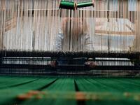 This picture shows a woman at work in the laboratory of Antico setificio Fiorentino ancient silk factory in Florence. 
Tiziana FABI / AFP