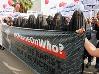 Activists hold banners against sexual assaults during the 16th edition of the Beirut Marathon on November 11, 2018. 
ANWAR AMRO / AFP