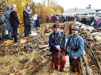 Inhabitants of Souille and La Guierche and history enthusiast, dressed with vintage army uniforms of Poilu (French soldier in World War I), stand guard in a reconstructed trench of the WWI, as they take part in a ceremony to inaugurate the trench on November 11, 2018 
JEAN-FRANCOIS MONIER / AFP