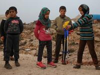 Maya Merhi (C) stands among her friends in the Internally Displaced Persons (IDP) camp of Serjilla in northwestern Syria, next to Bab al-Hawa border crossing with Turkey.
Aaref WATAD / AFP