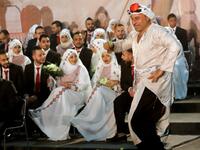 A man dressed in traditional Palestinian clothing dances during a mass wedding ceremony in the Lebanese fishing town of Rmaile, south of the capital Beirut
Mahmoud ZAYYAT / AFP