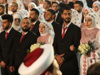 Newly-wed couples are seen during a mass wedding ceremony for 150 Palestinian couples and 50 other Lebanese couples
Mahmoud ZAYYAT / AFP