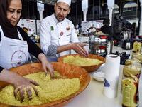 An Algerian chef directs a woman as they prepare couscous during the 2nd edition of the International Couscous Festival at the Moufdi Zakaria Palace of Culture in Algeria
RYAD KRAMDI / AFP