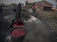 A young man boils cow blood before the sun-drying process to make fertiliser at Kaduna Abatour meat market in North Kaduna CRISTINA ALDEHUELA / AFP