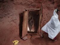Ethiopian Orthodox devotees enter inside a tunnel leading to the rock-hewn church of Saint Emmanuel, in Lalibela, Ethiopia 
EDUARDO SOTERAS / AFP