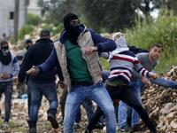 Palestinian protesters throw stones towards Israeli forces during clashes following a weekly demonstration against the expropriation of Palestinian land by Israel in the village of Kfar Qaddum, near Nablus 
JAAFAR ASHTIYEH / AFP