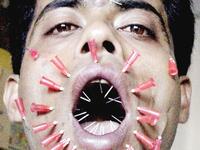Patesh Talukdar, from Assam state, pierces his face with 23 needles during an attempt to make it into the annals of the Guinness Book of World Records November 11, 2002 in Guwahati. Talukdar has already made it into the Limca book of records with his bizarre feat of consuming bulbs and bricks. (AFP Photo)