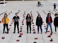 Israelis walk past an installation of red shoes during a rally against domestic violence in the Israeli coastal city of Tel Aviv on December 4, 2018 (Twitter)