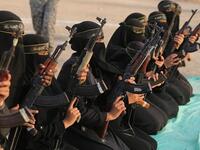 The women of the al-Quds Brigades holding Kalashnikov rifles and poised for action during the exercise at Khan Yunis on the southern section of the Gaza Strip (APA/Shutterstock)